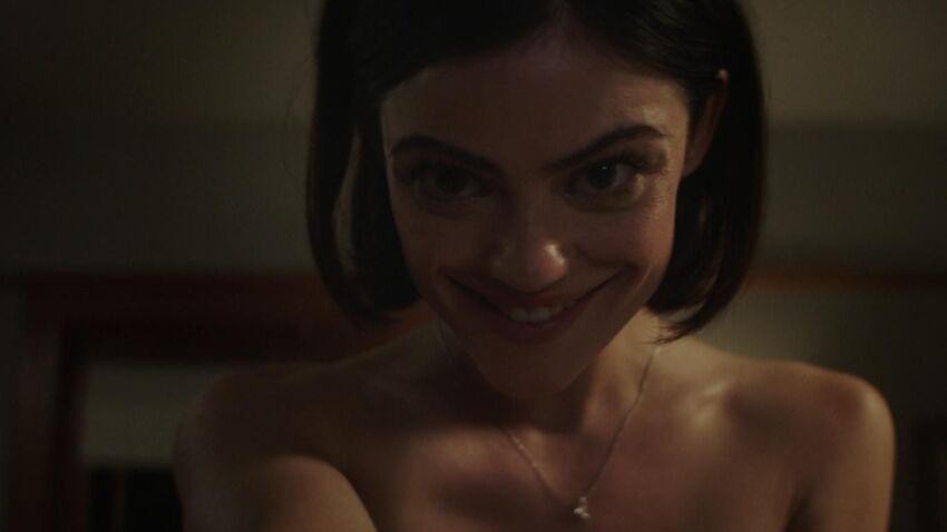 aware black_hair bottomless breasts brown_eyes collarbone evil_smile female_only looking_at_viewer necklace nightmare_fuel nude olivia_barron possession pov real screenshot short_hair small_breasts smile solo topless truth_or_dare_(film)