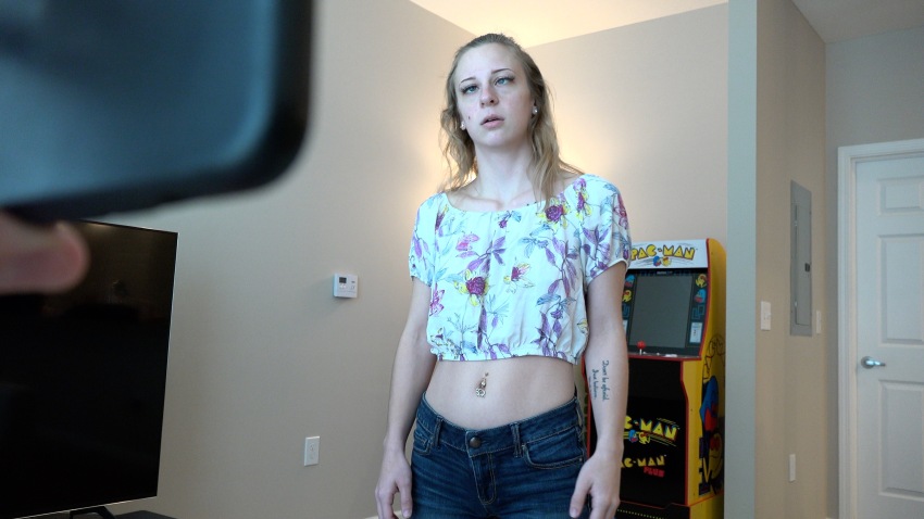 absurdres blonde_hair collarbone earrings expressionless femsub girlsgonehypnotized heavyn_(girlsgonehypnotized) jean_shorts jewelry long_hair maledom mole navel_piercing open_mouth piercing pov pov_dom real screenshot standing standing_at_attention tattoo